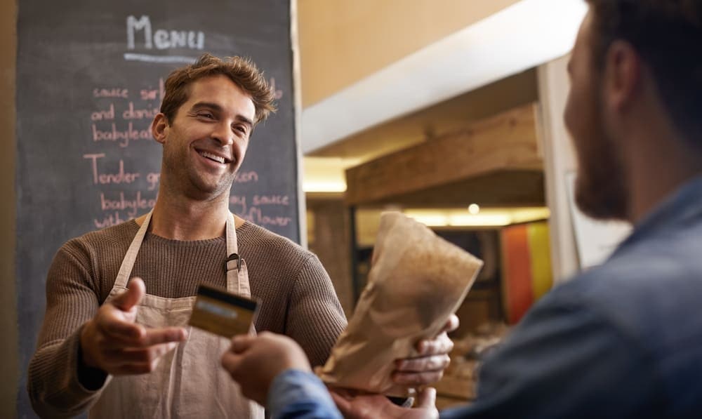 A happy customer shopping at a food stall